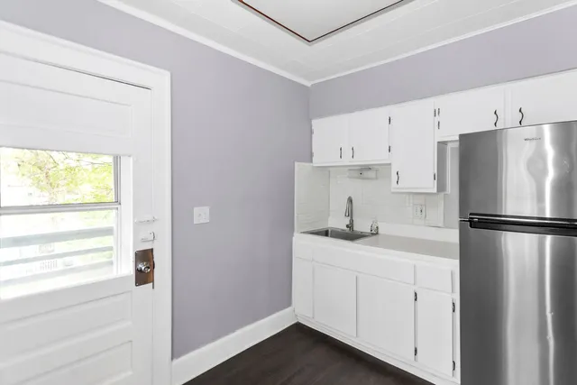 a kitchen with a refrigerator sink stove and cabinets