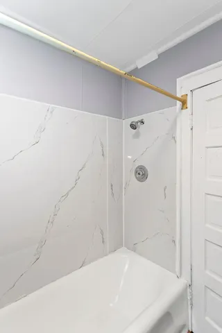 a bathroom with a bathtub and a shower