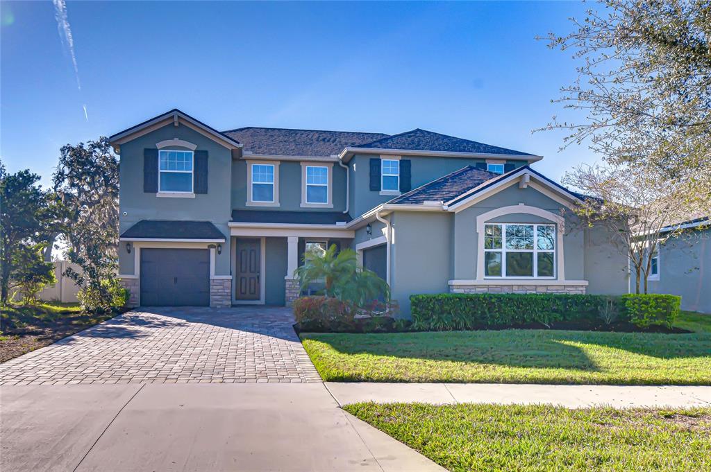 a front view of a house with a yard and garage