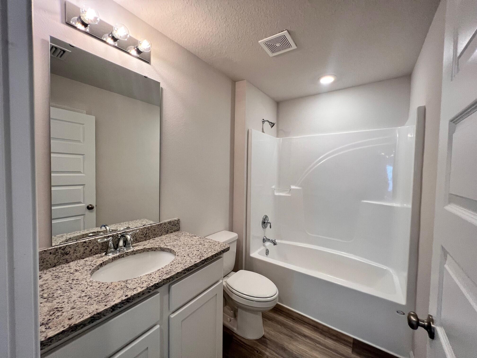 526 Mary Lou Way Crestview, FL 32539 - Photo 10 of 18 a bathroom with a granite countertop sink toilet and shower