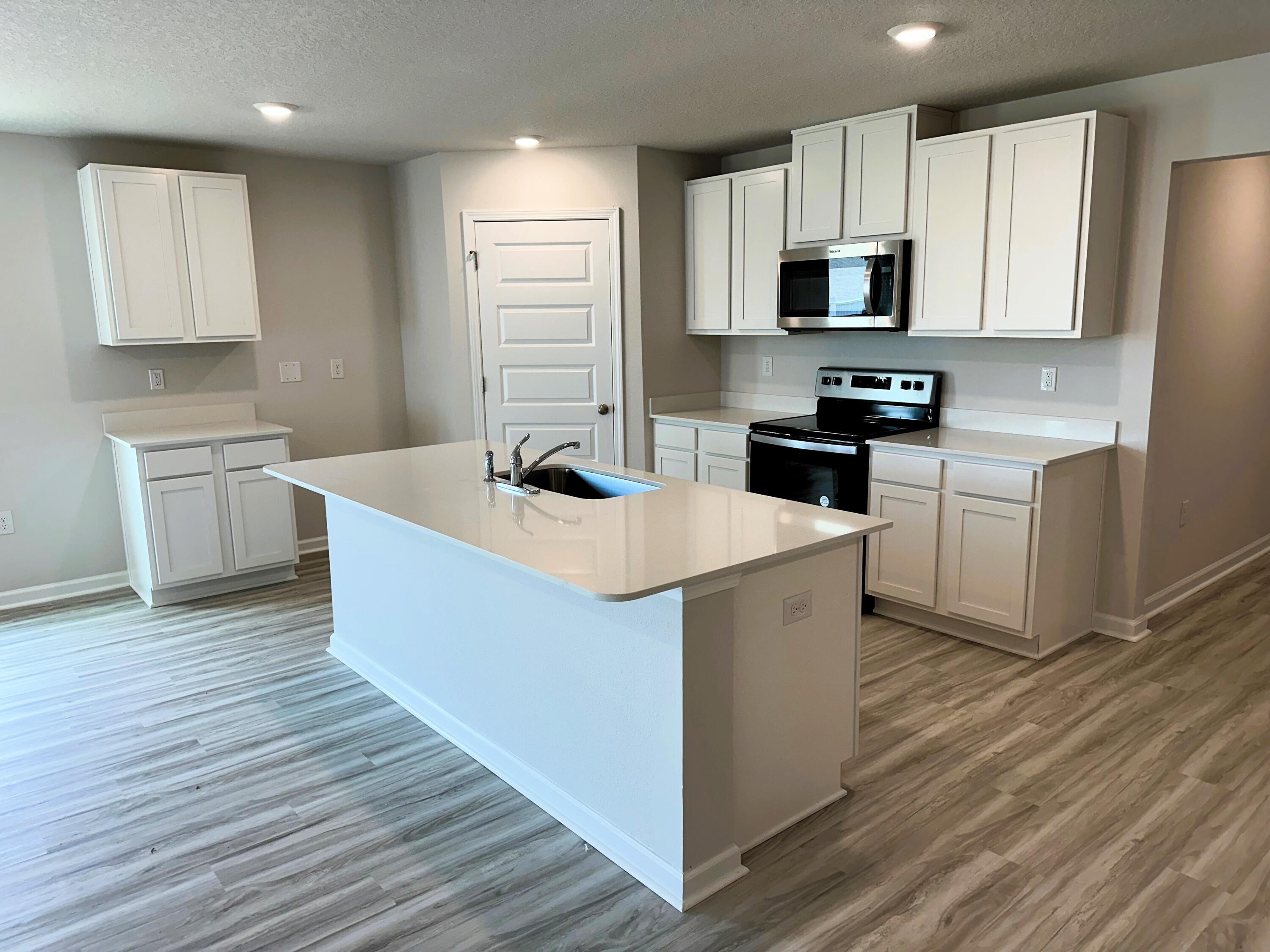 526 Mary Lou Way Crestview, FL 32539 - Photo 7 of 18 a kitchen with stainless steel appliances a sink a stove top oven a counter space and cabinets