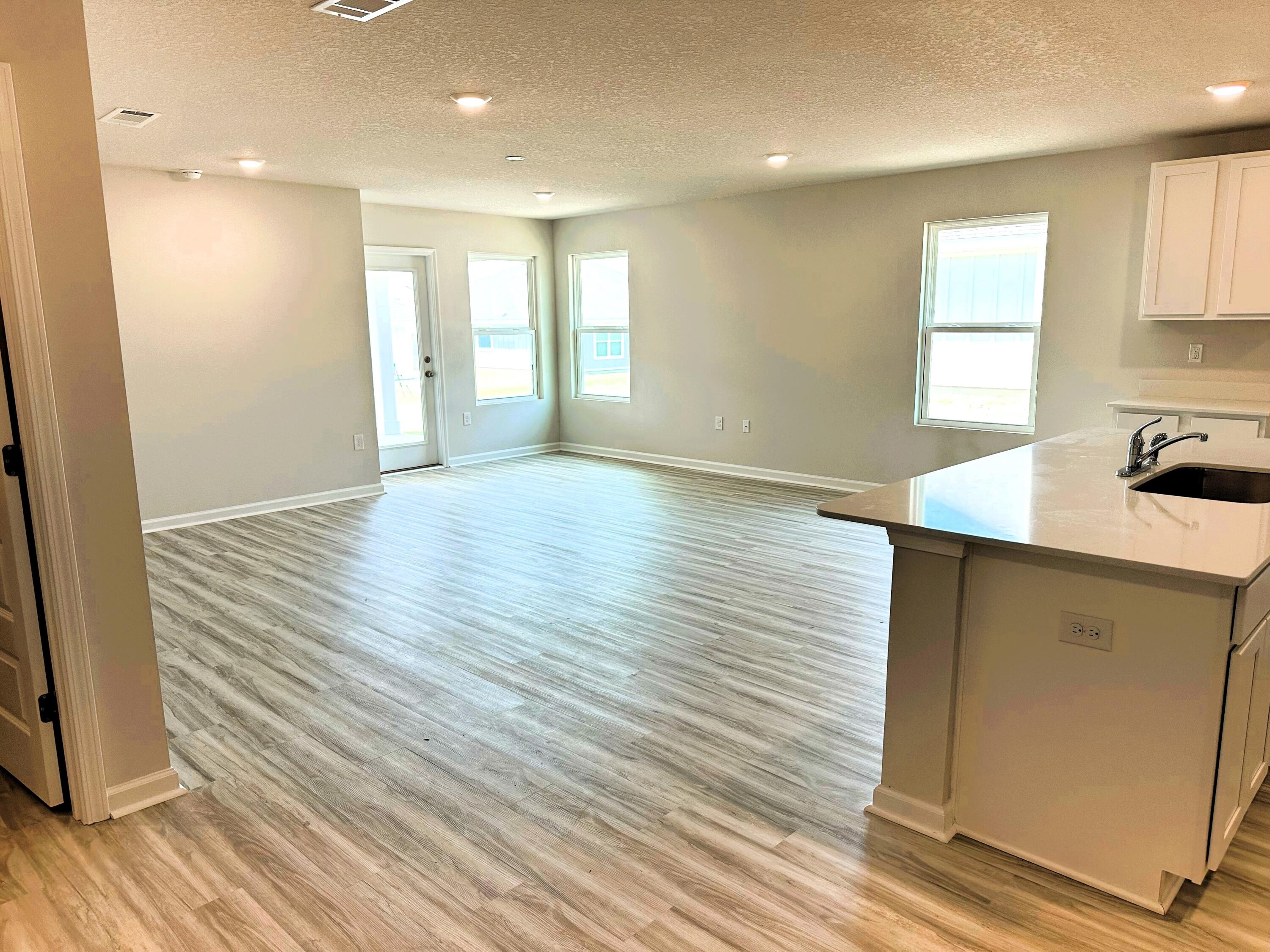 526 Mary Lou Way Crestview, FL 32539 - Photo 8 of 18 a view of a kitchen with wooden floor and a sink