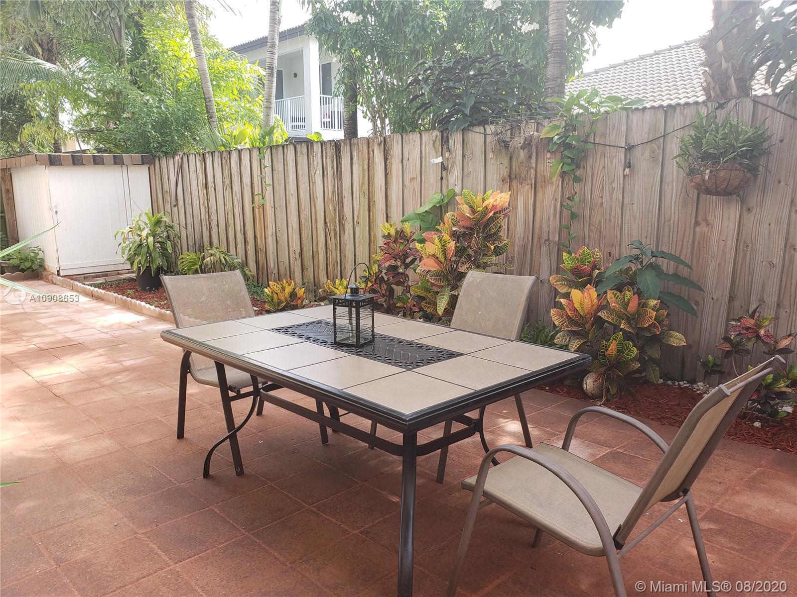 2580 Southwest 147 Path Miami, FL 33185 - Photo 11 of 11 a table and chairs in front of a house