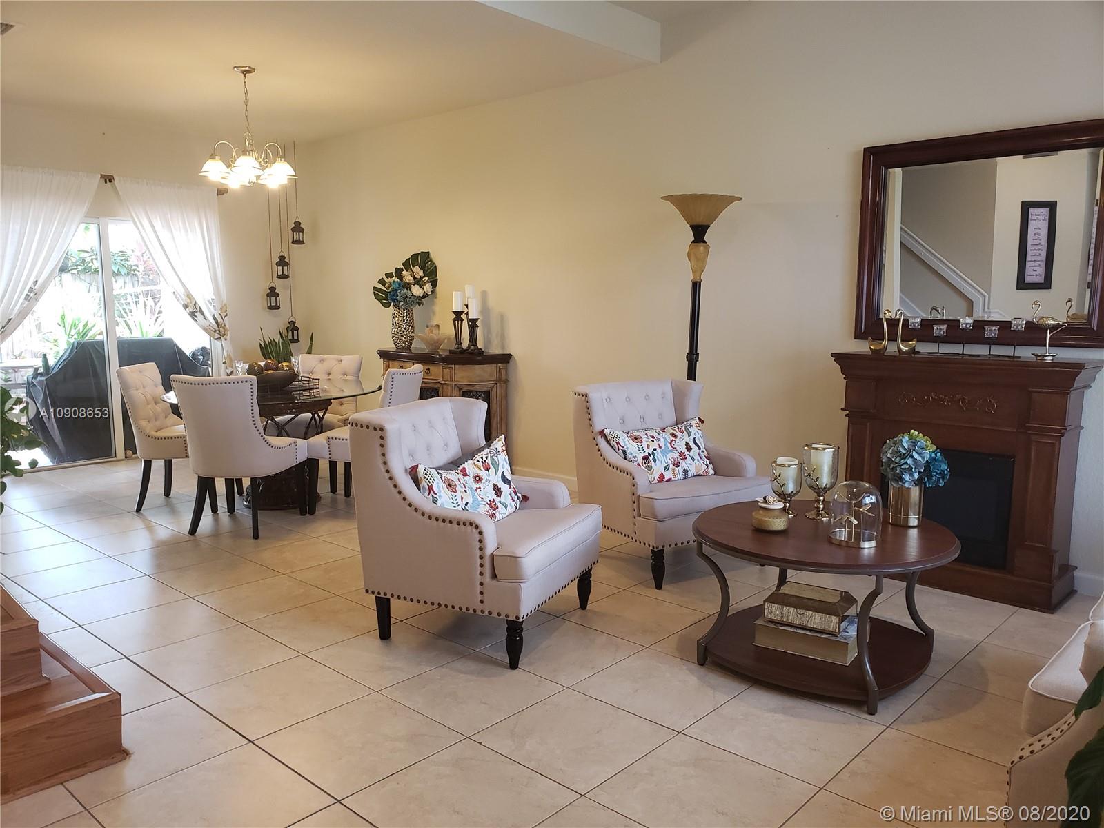 2580 Southwest 147 Path Miami, FL 33185 - Photo 2 of 11 a living room with furniture a chandelier and a fireplace