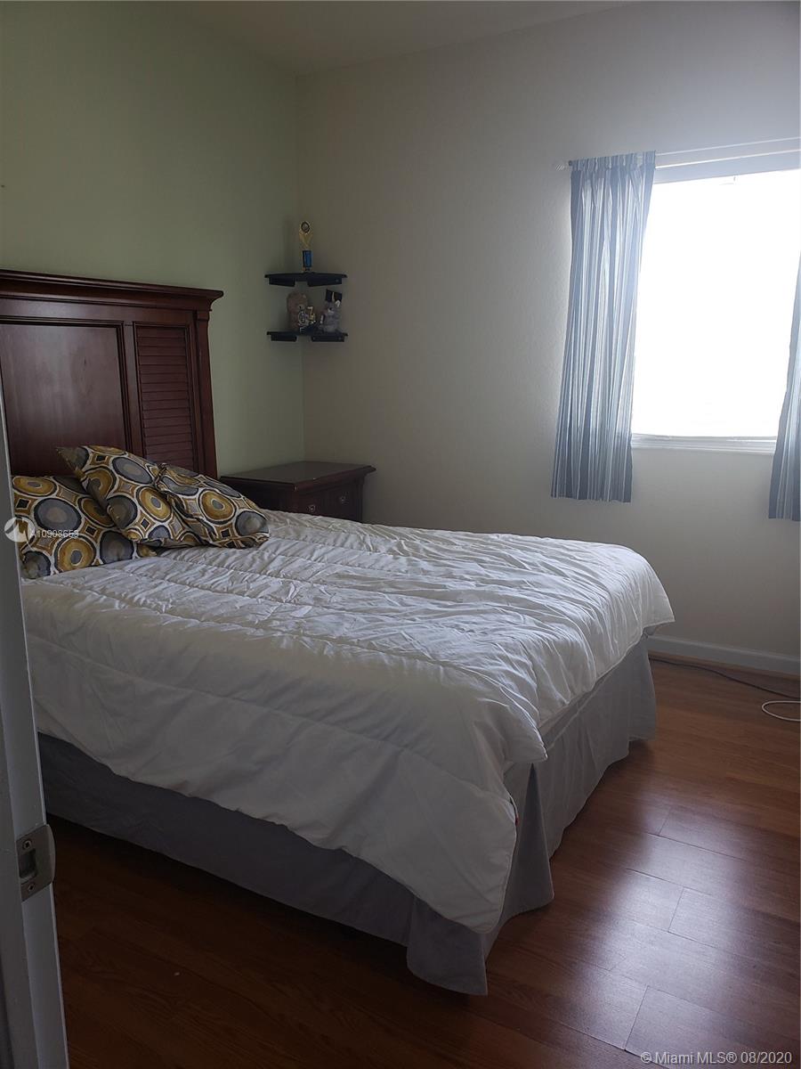 2580 Southwest 147 Path Miami, FL 33185 - Photo 6 of 11 a bedroom with a bed and a window