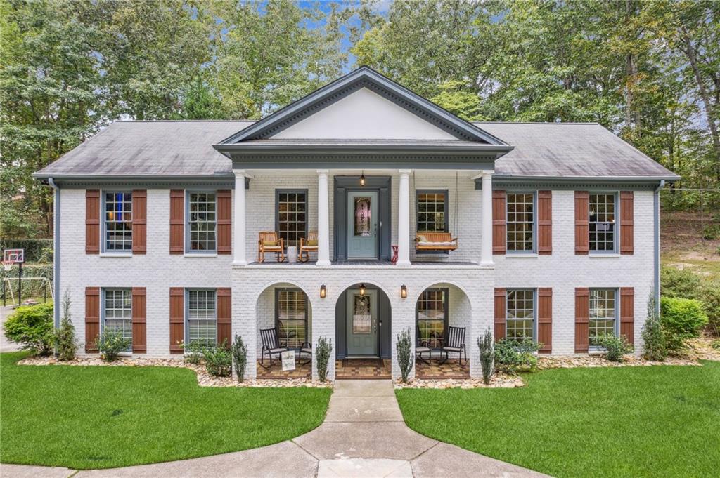 a front view of a house with garden
