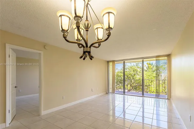 a view of a room with a floor to ceiling window and a rug