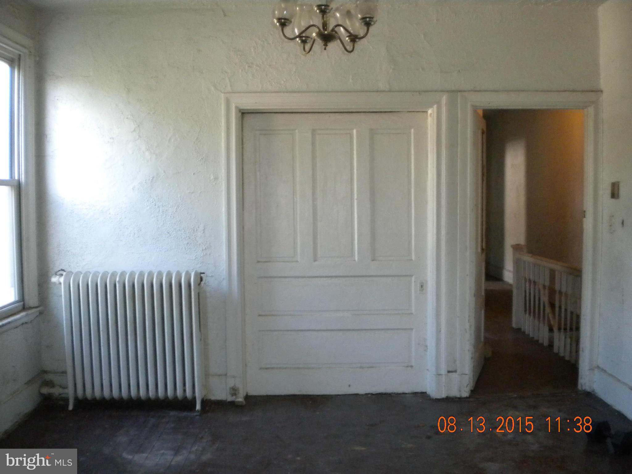 1719 Lincoln Road Northeast Washington, DC 20002 - Photo 3 of 27 an empty room with a wooden door