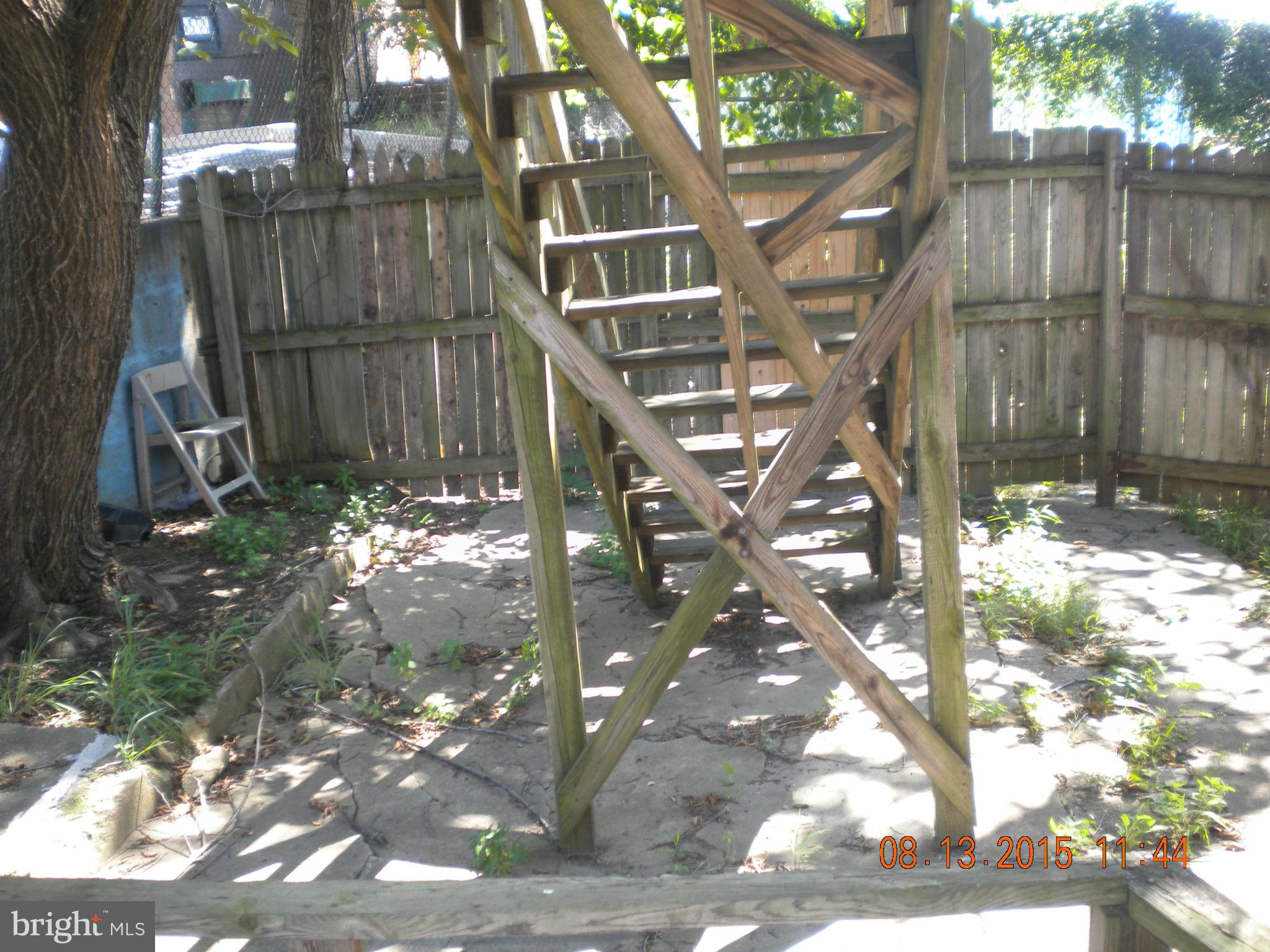 1719 Lincoln Road Northeast Washington, DC 20002 - Photo 22 of 27 a backyard of a house with table and chairs