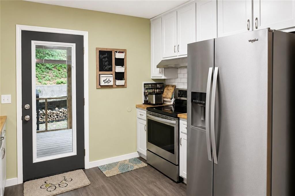 2033 Carson Segars Road Maysville, GA 30558 - Photo 13 of 41 a kitchen with stainless steel appliances a refrigerator sink and cabinets