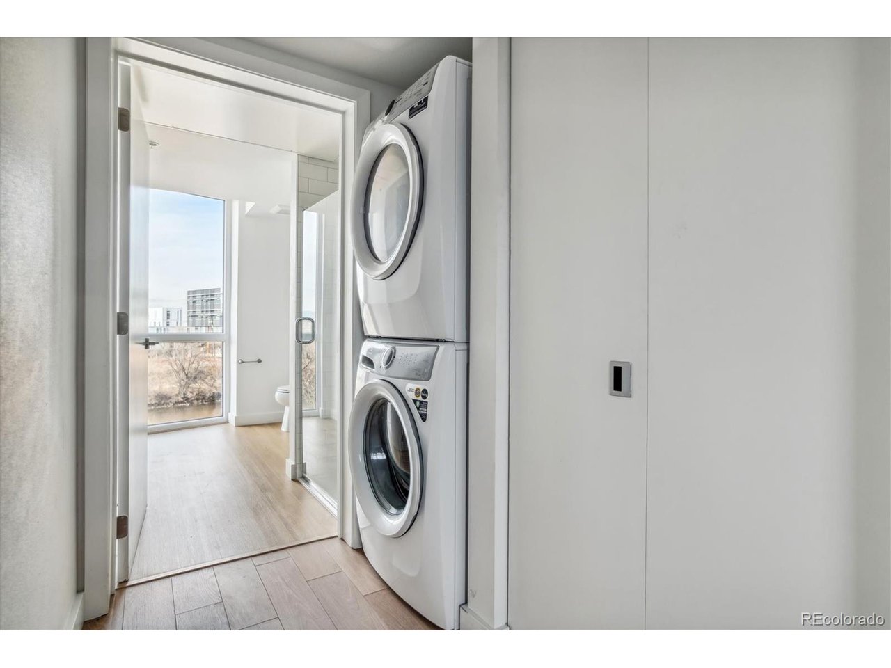 3575 Chestnut Place, Unit 406 Denver, CO 80216 - Photo 6 of 16 a view of a hallway with washer and dryer