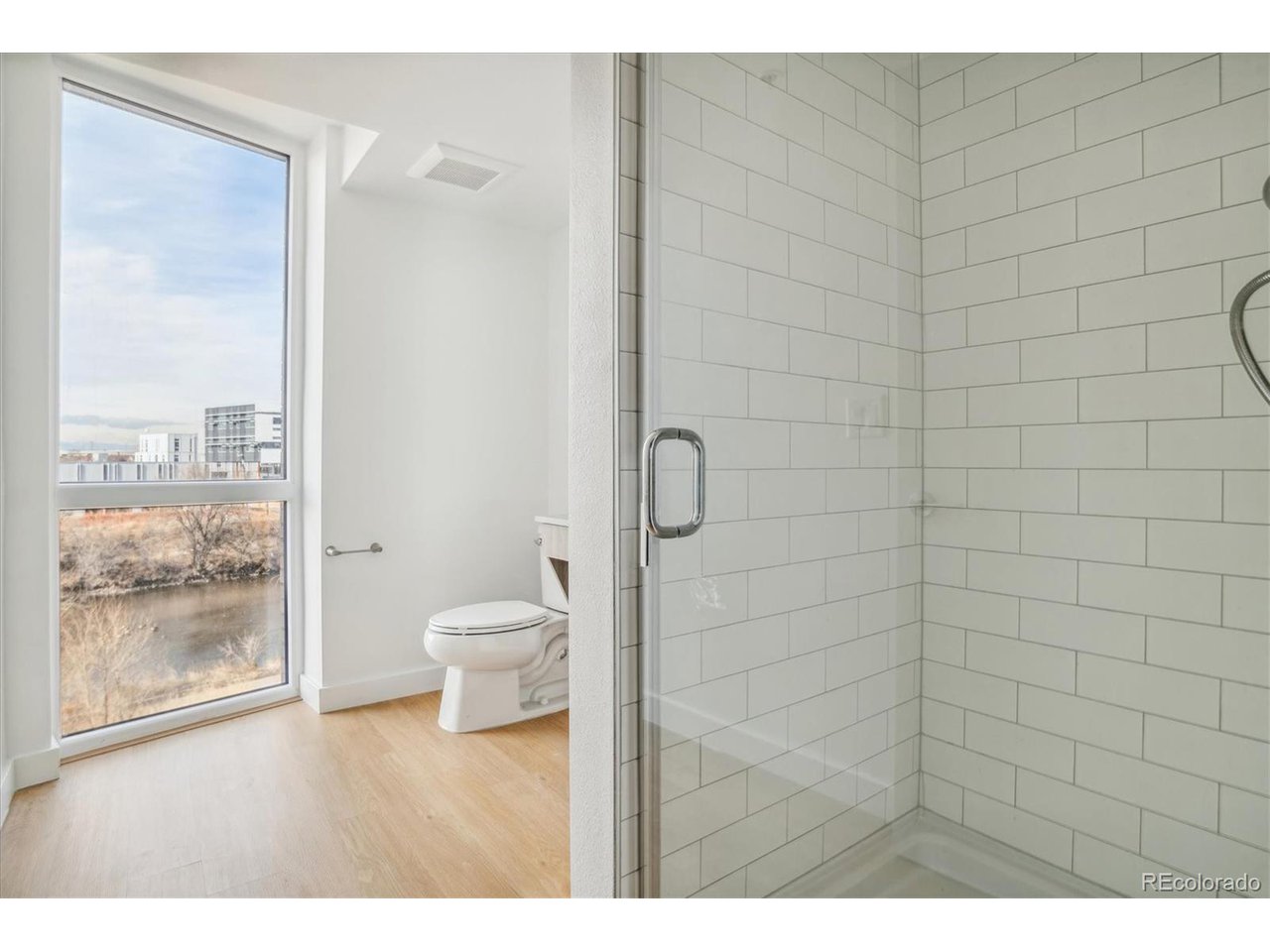 3575 Chestnut Place, Unit 406 Denver, CO 80216 - Photo 7 of 16 a bathroom with a toilet and a shower