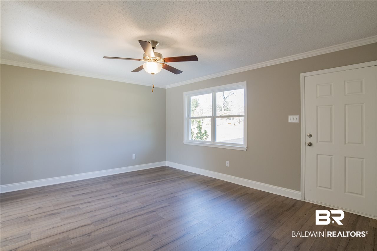 9141 Semmes Court Semmes, AL 36575 - Photo 4 of 28 Bright living room with new Low E vinyl windows.