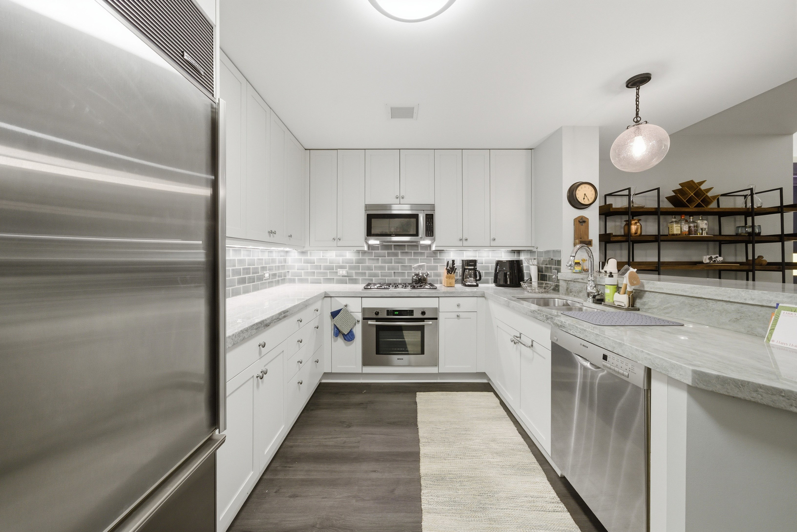 60 East Monroe Street, Unit 5304 Chicago, IL 60603 - Photo 12 of 55 a kitchen with stainless steel appliances granite countertop a stove top oven a sink and dishwasher