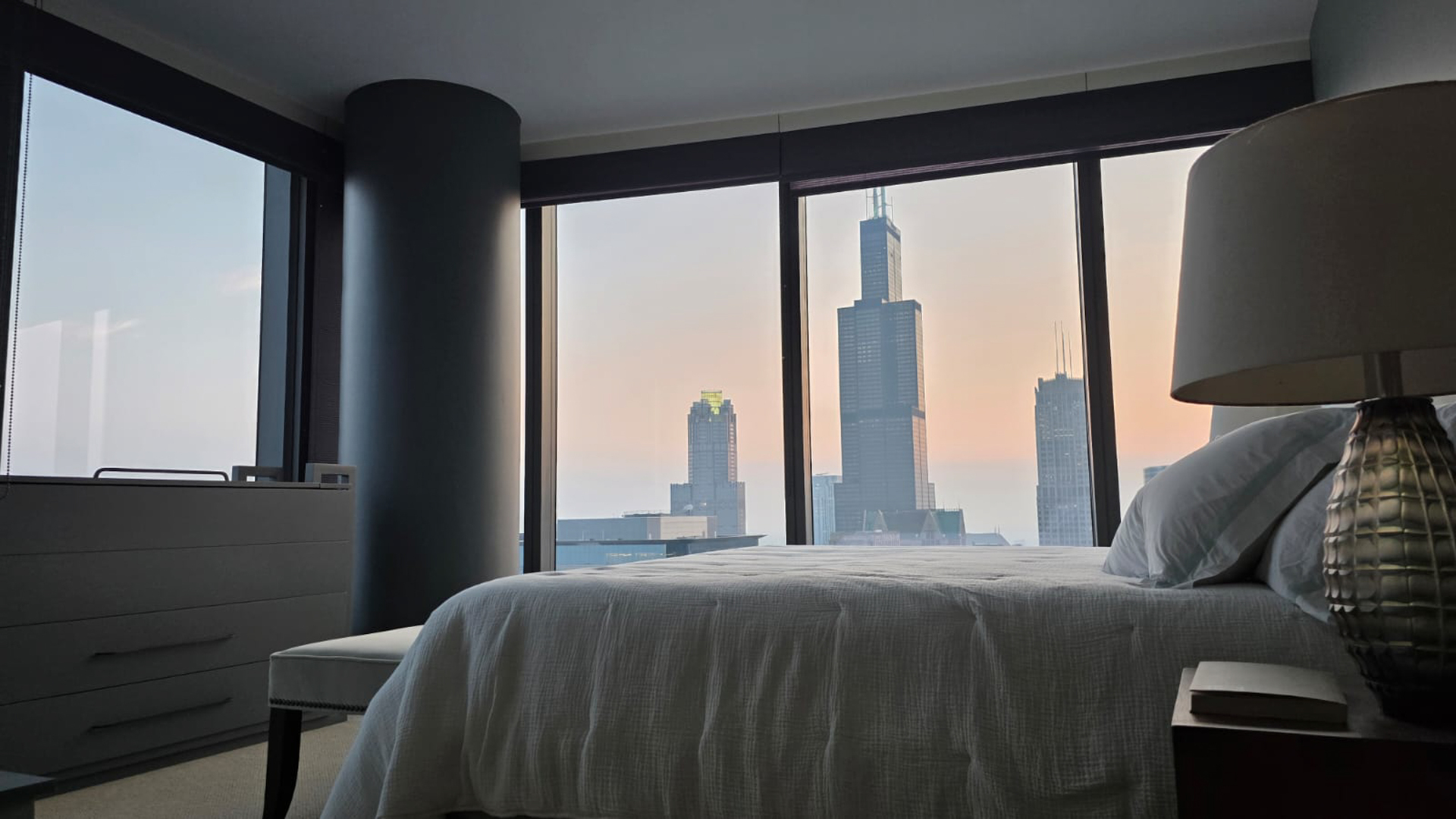 60 East Monroe Street, Unit 5304 Chicago, IL 60603 - Photo 19 of 55 a bedroom with a large window and a bed