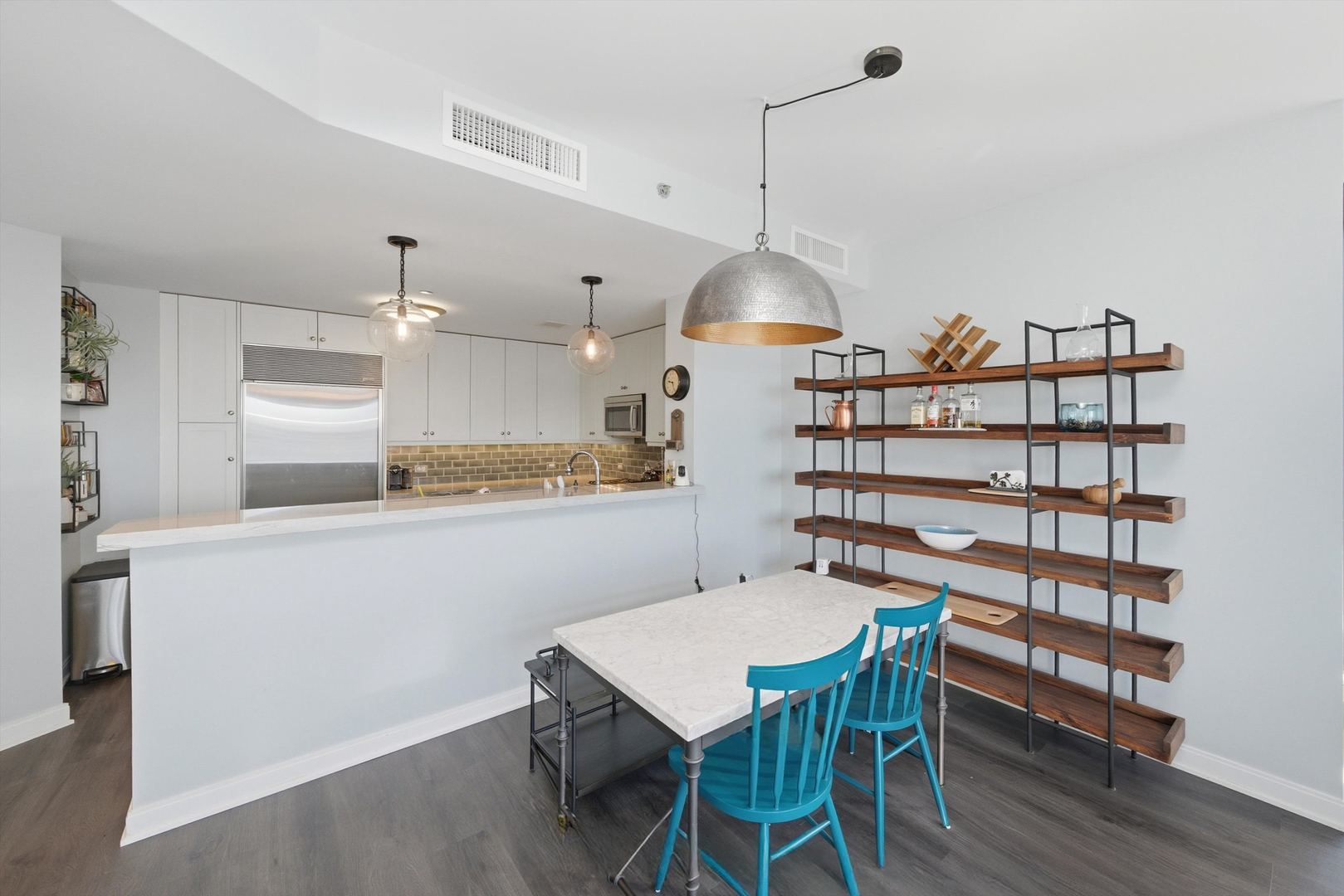 60 East Monroe Street, Unit 5304 Chicago, IL 60603 - Photo 8 of 55 a kitchen with a table and chairs in it