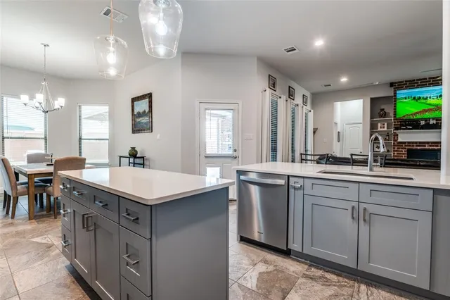 a view of a dining room with furniture and a chandelier