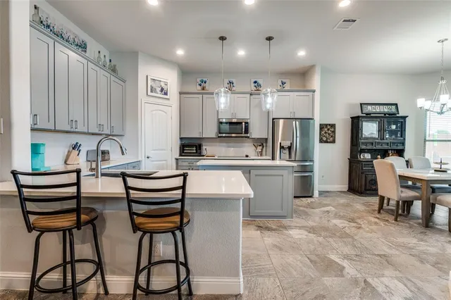 a view of a dining room with furniture and chandelier