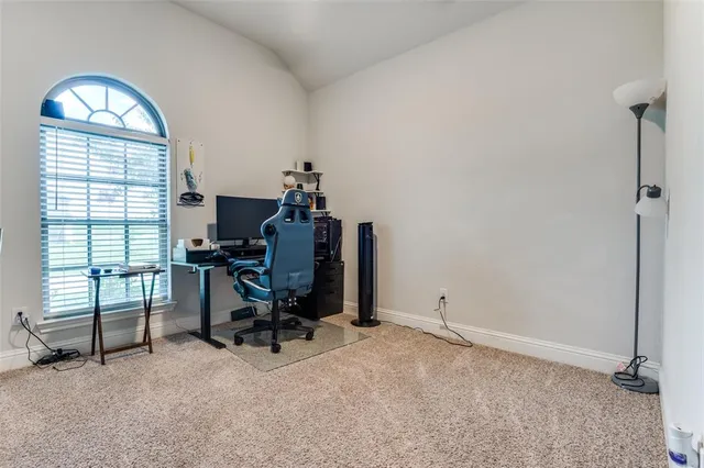 a view of a patio with a table and chairs under an umbrella