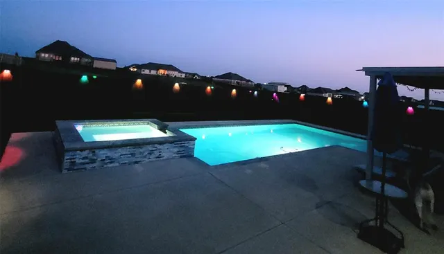 an aerial view of a house with a garden and lake view