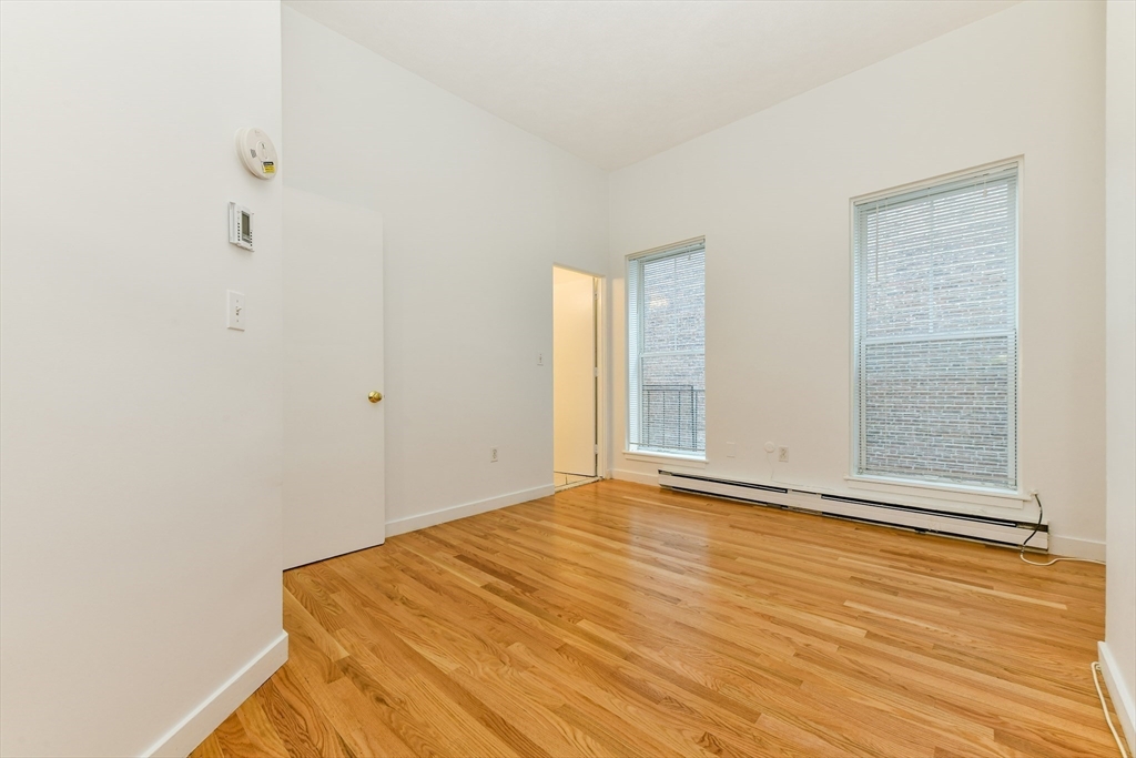 99-101 West Springfield Street Boston, MA 02118 - Photo 12 of 31 a view of an empty room with wooden floor and a window