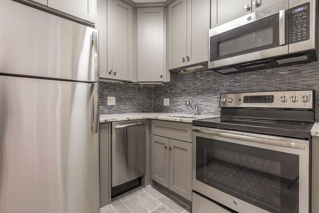 a kitchen with stainless steel appliances granite countertop a refrigerator stove a sink and dishwasher