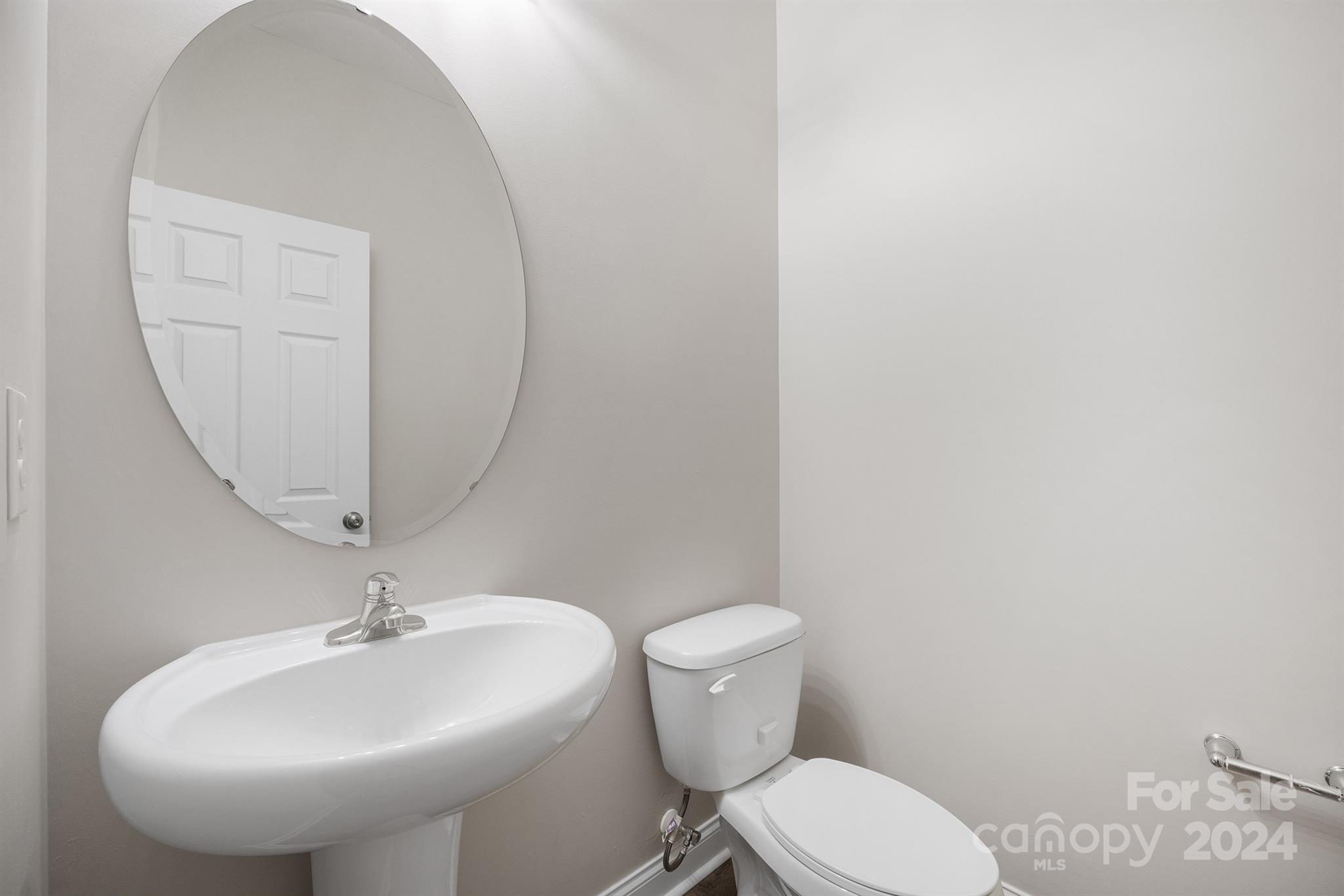 4009 Thorndale Road Indian Trail, NC 28079 - Photo 18 of 48 a bathroom with a toilet a sink and a mirror