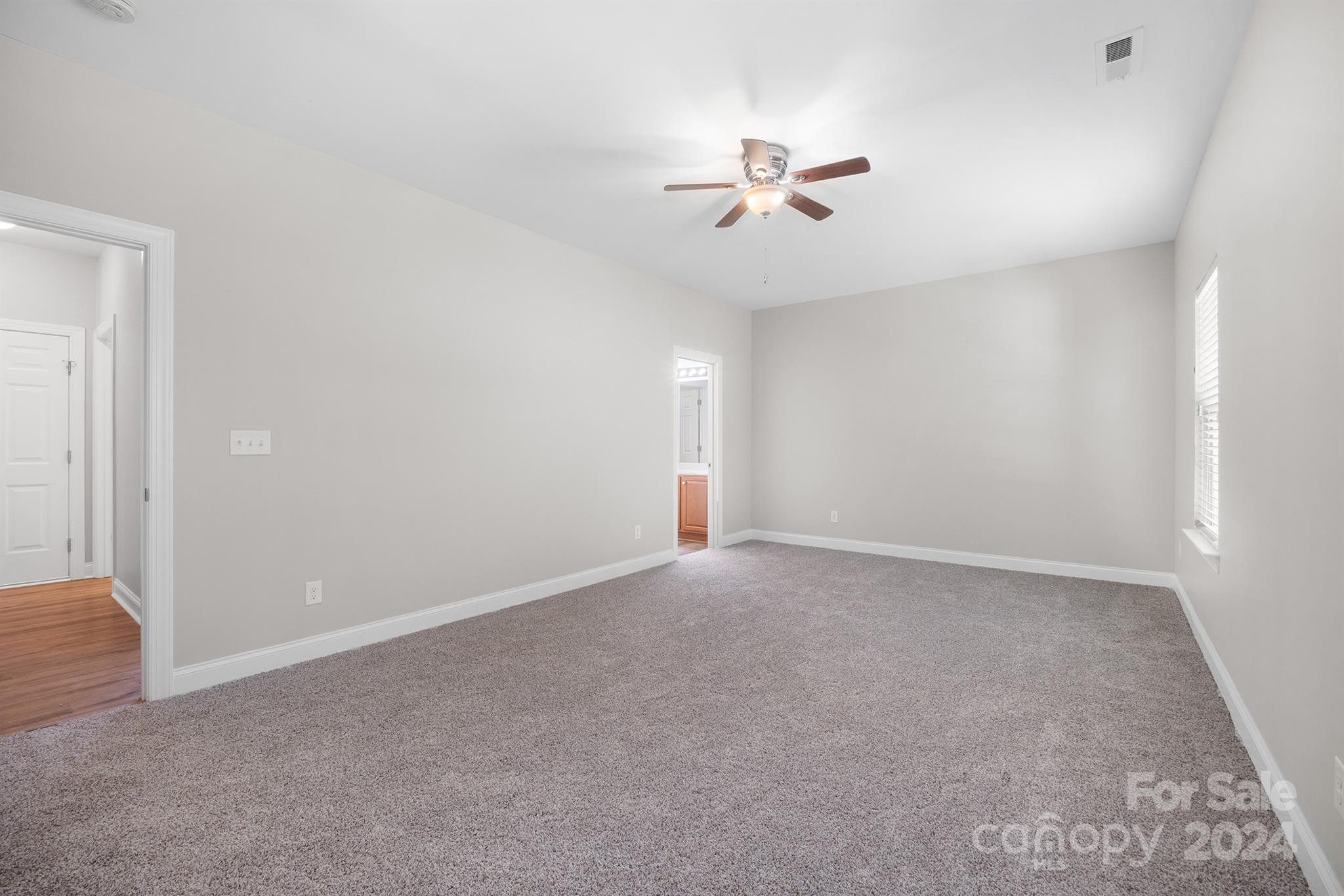 4009 Thorndale Road Indian Trail, NC 28079 - Photo 19 of 48 a view of an empty room with a chandelier fan