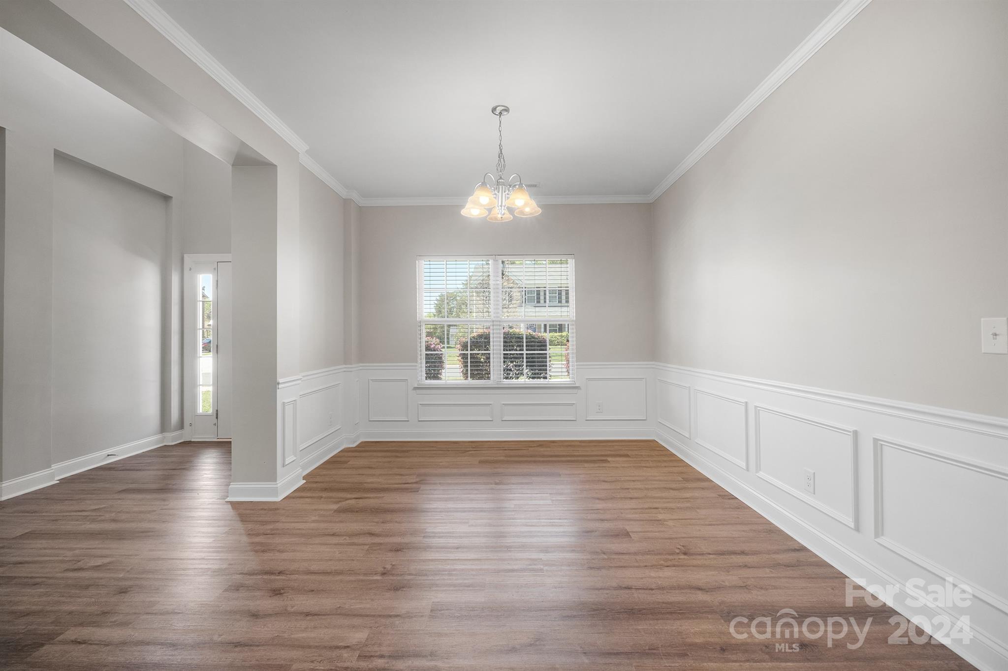 4009 Thorndale Road Indian Trail, NC 28079 - Photo 2 of 48 a view of an empty room with wooden floor and a window