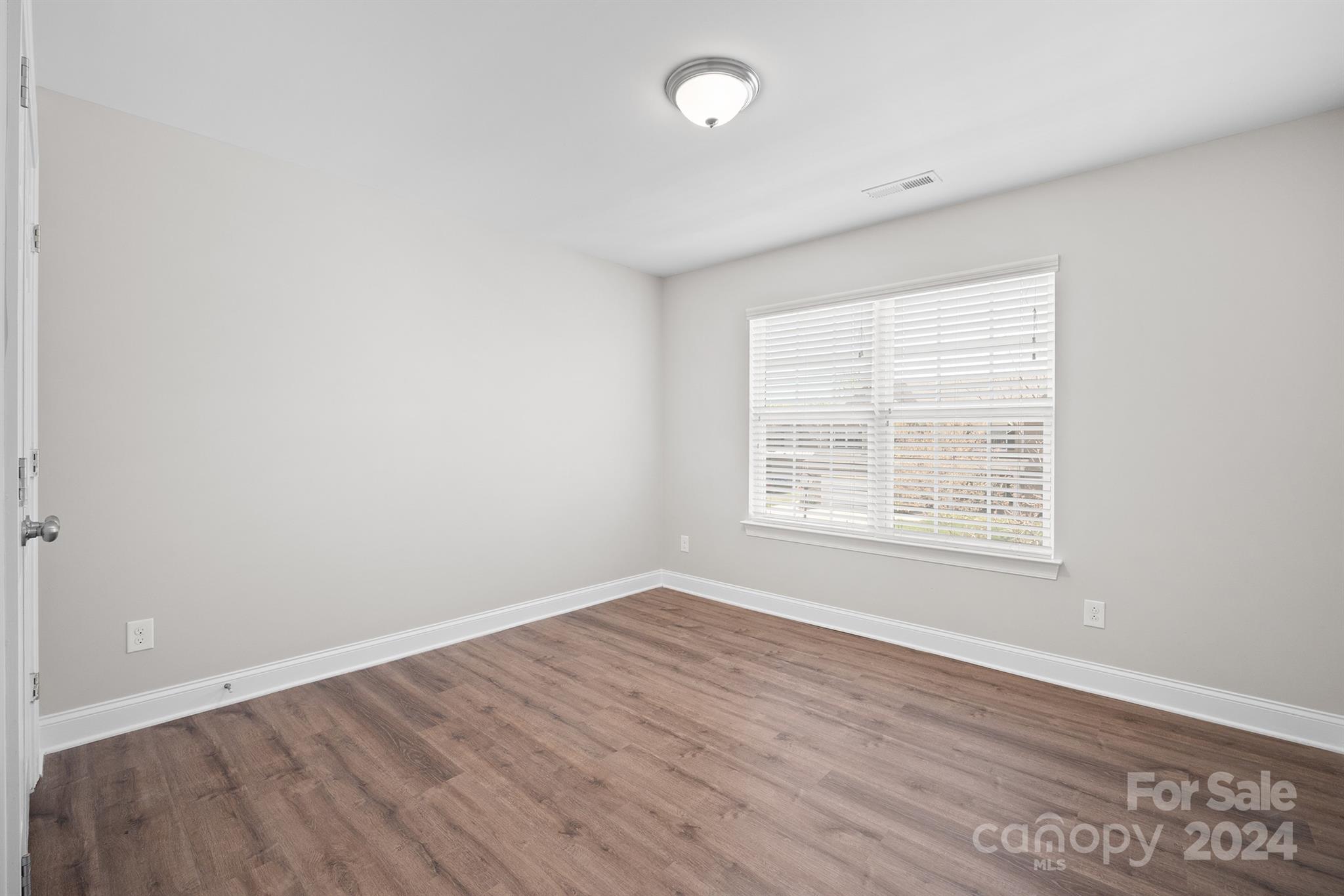 4009 Thorndale Road Indian Trail, NC 28079 - Photo 25 of 48 an empty room with wooden floor and windows