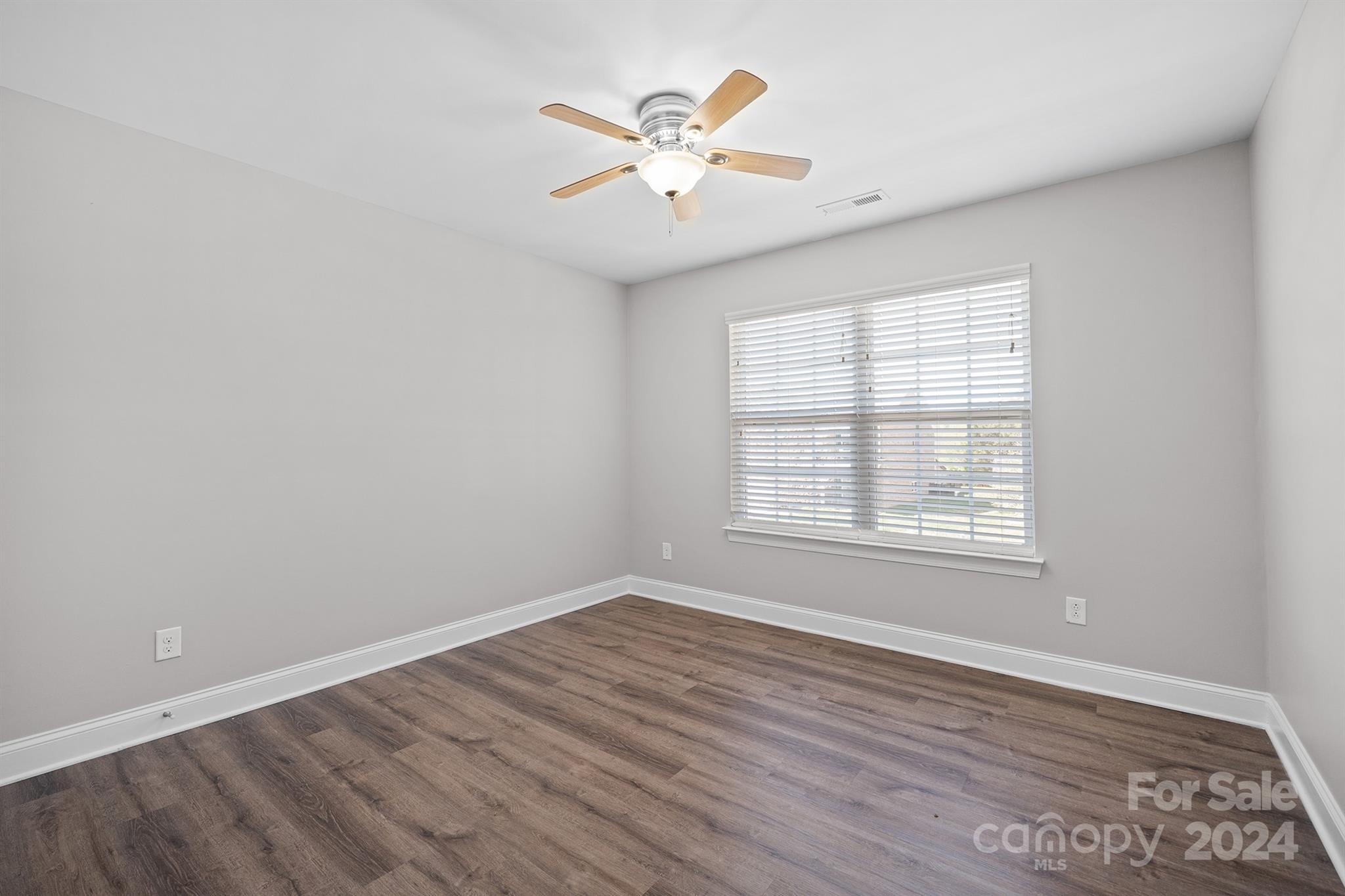 4009 Thorndale Road Indian Trail, NC 28079 - Photo 33 of 48 an empty room with wooden floor and windows