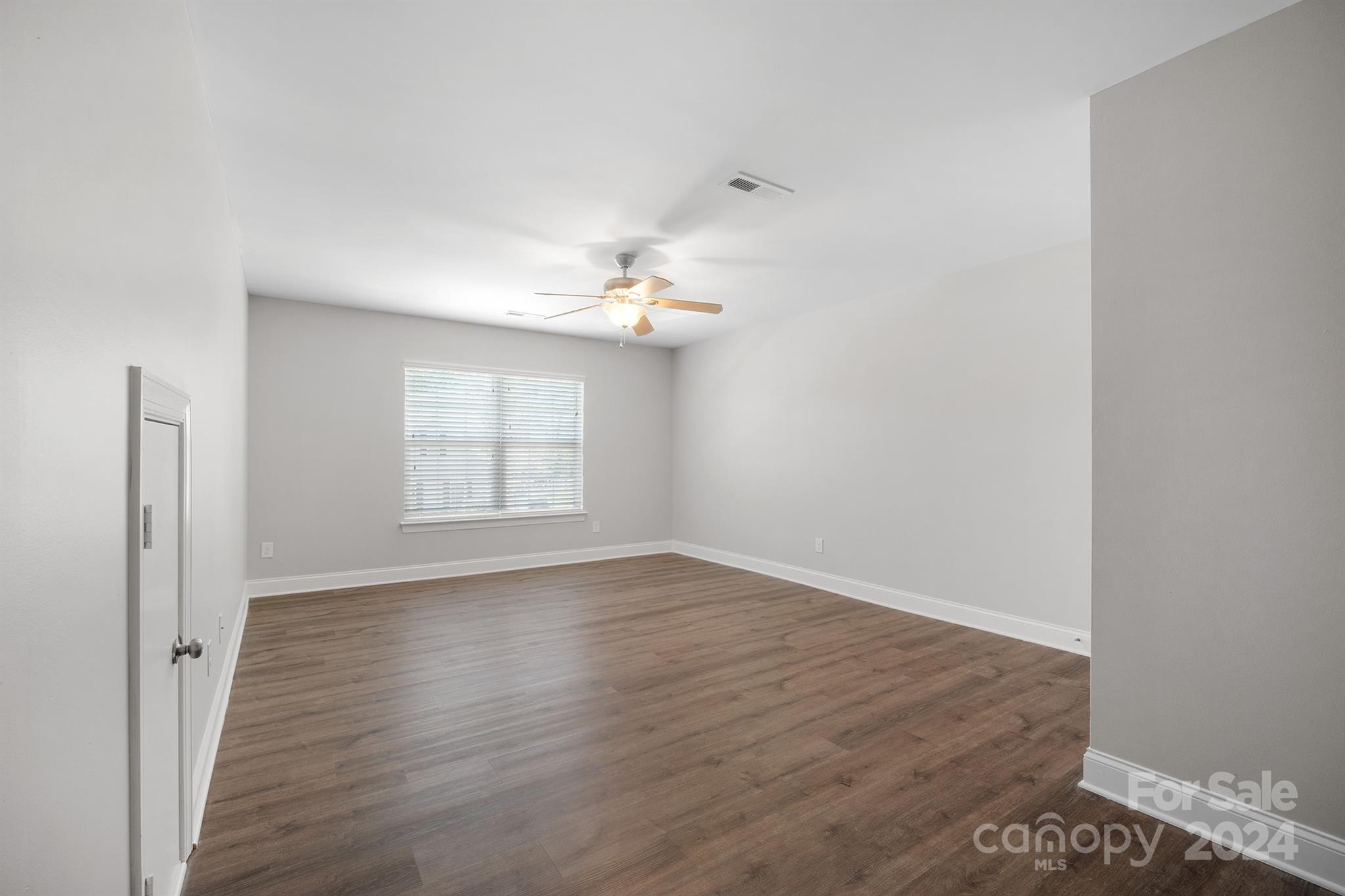 4009 Thorndale Road Indian Trail, NC 28079 - Photo 35 of 48 a view of an empty room with wooden floor and a window