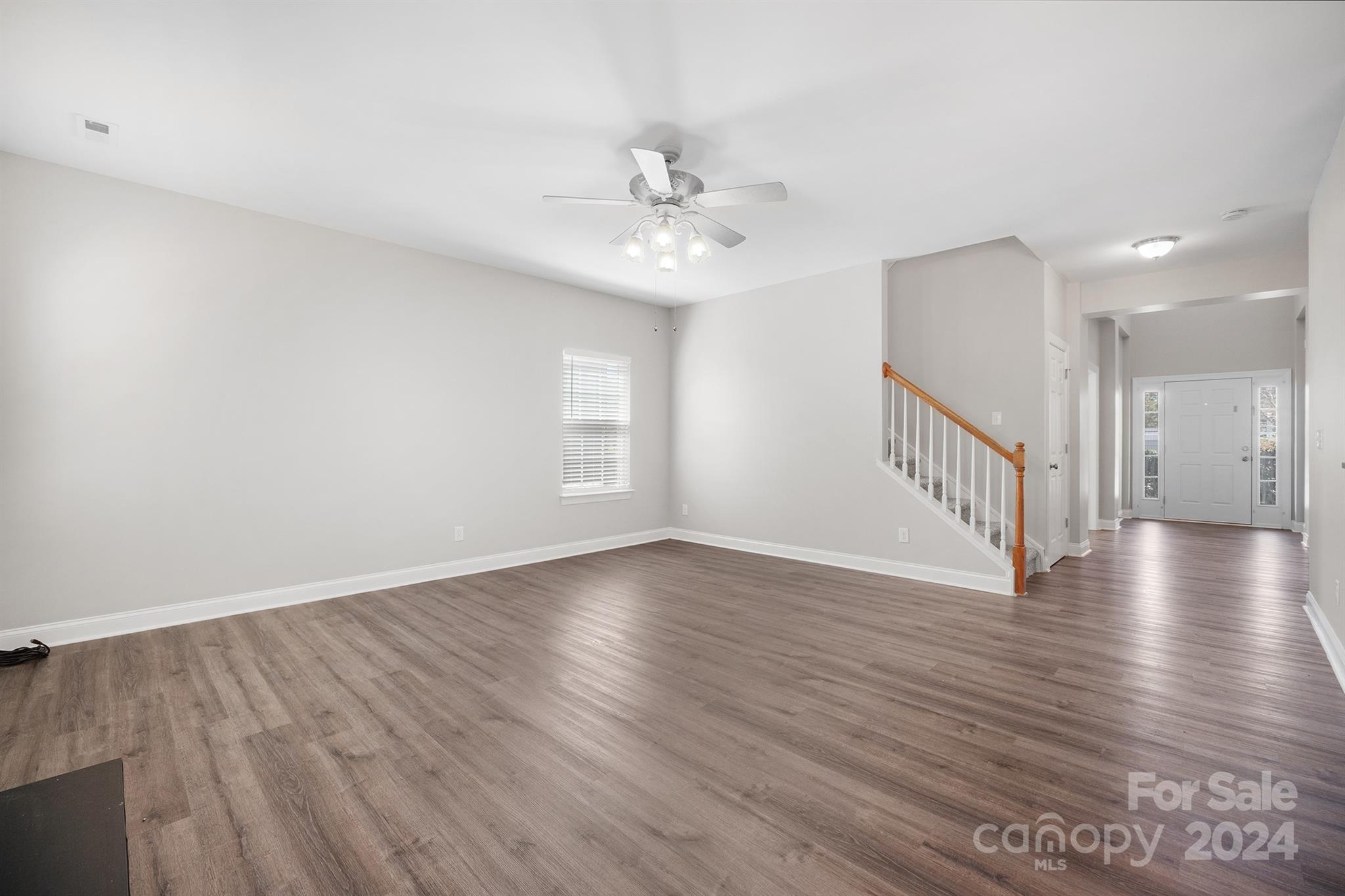 4009 Thorndale Road Indian Trail, NC 28079 - Photo 4 of 48 a view of an empty room with wooden floor and a window