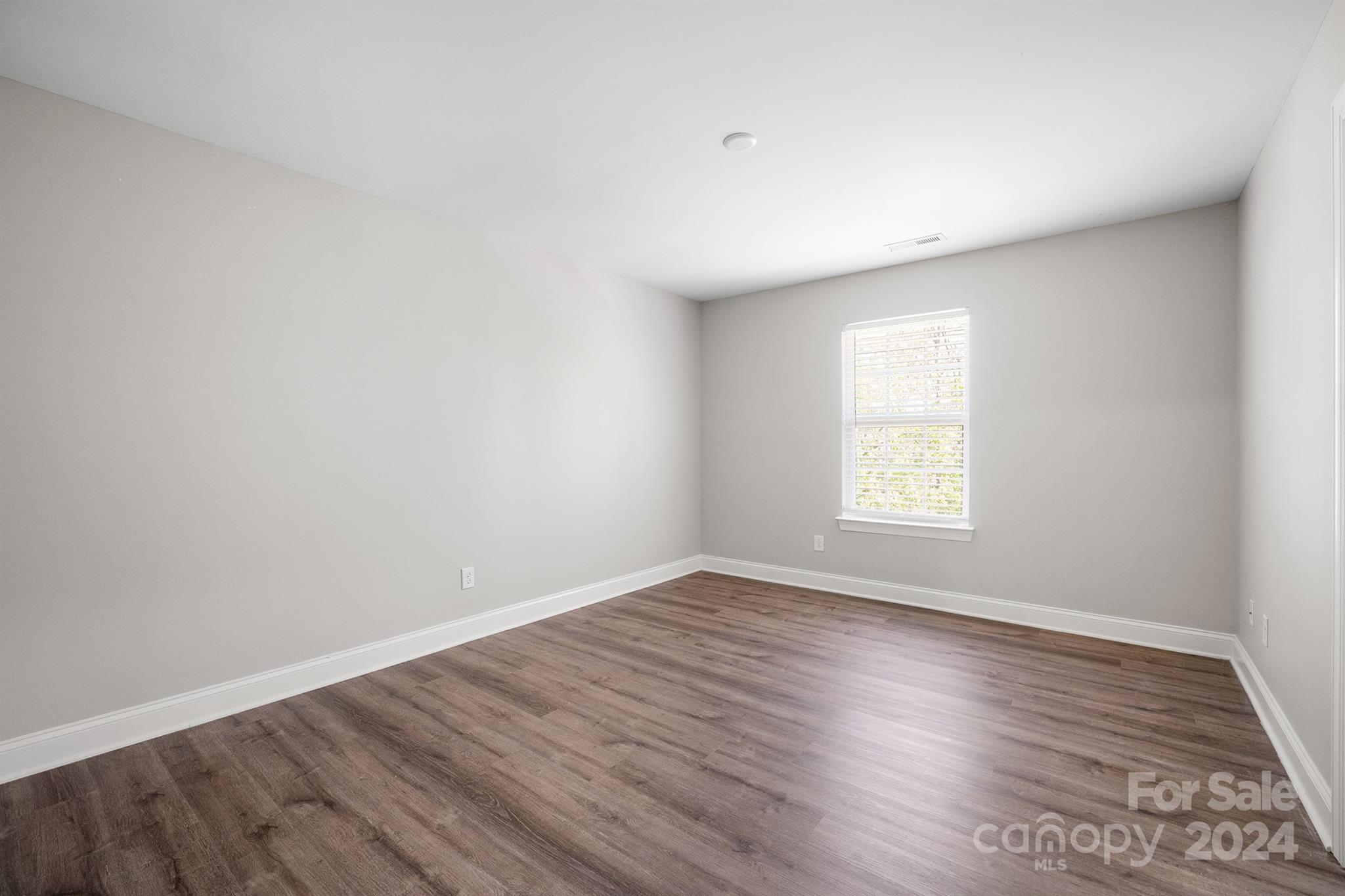 4009 Thorndale Road Indian Trail, NC 28079 - Photo 41 of 48 an empty room with wooden floor and window