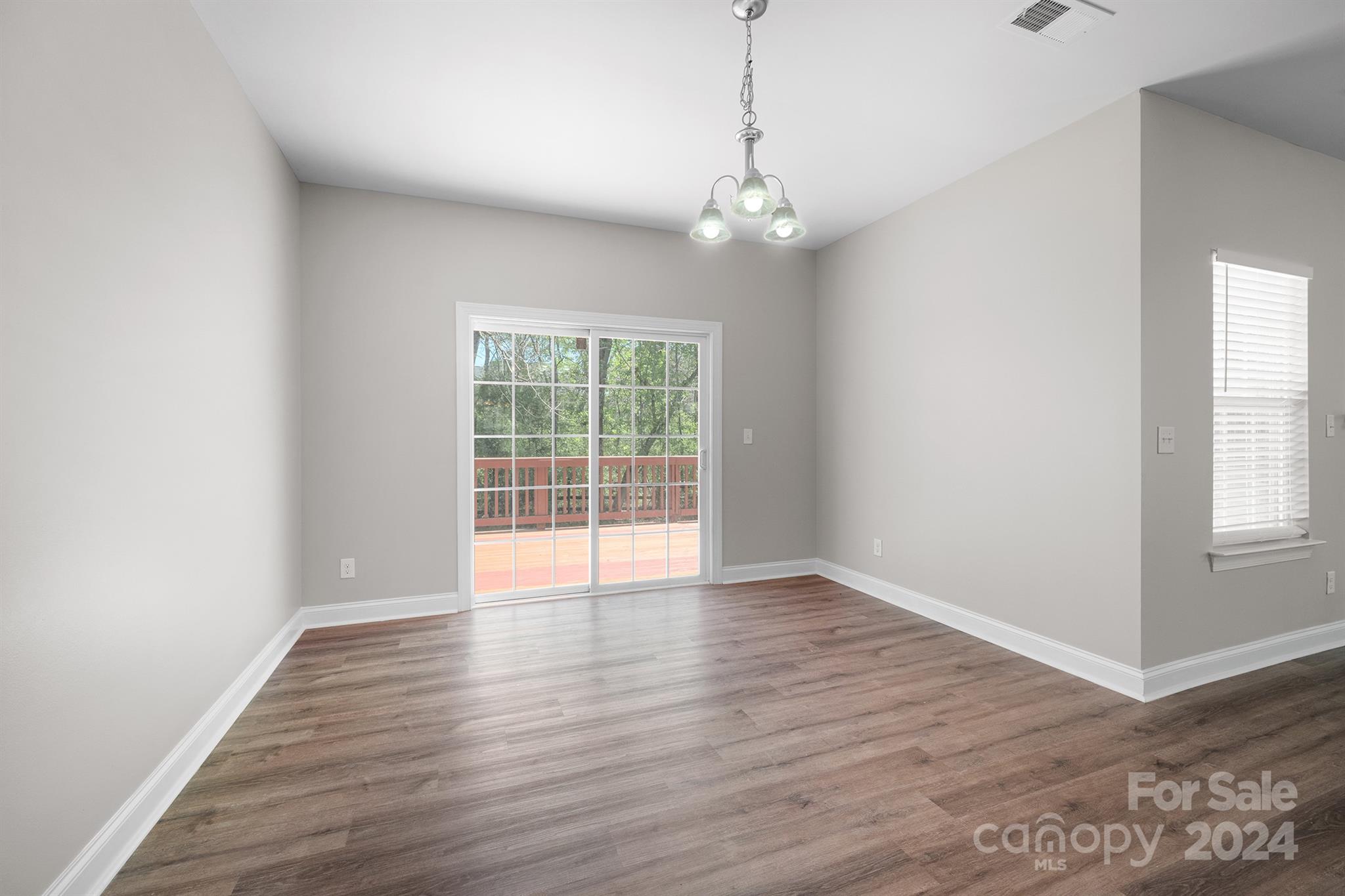 4009 Thorndale Road Indian Trail, NC 28079 - Photo 6 of 48 an empty room with wooden floor and windows