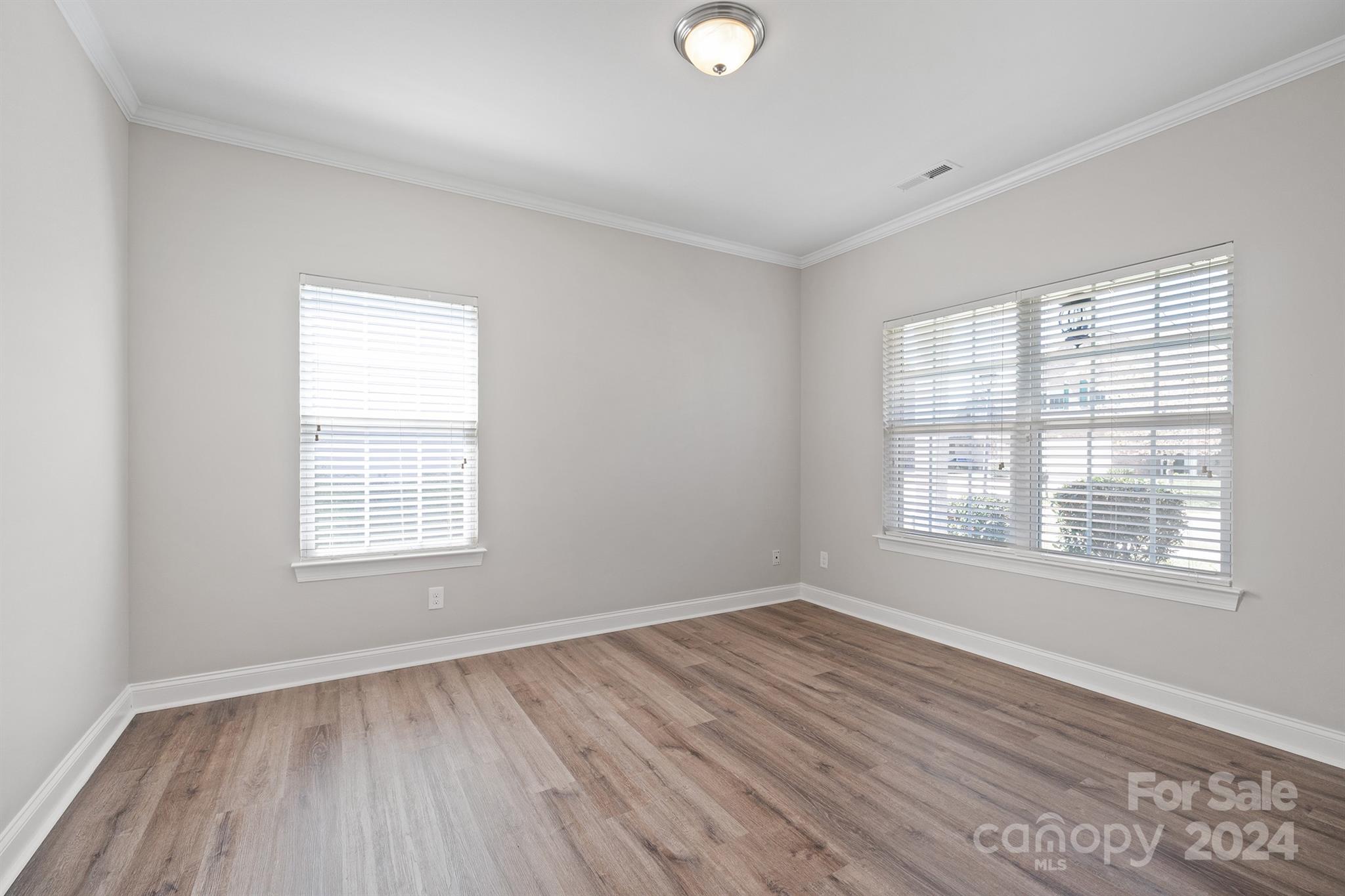 4009 Thorndale Road Indian Trail, NC 28079 - Photo 8 of 48 an empty room with wooden floor and windows