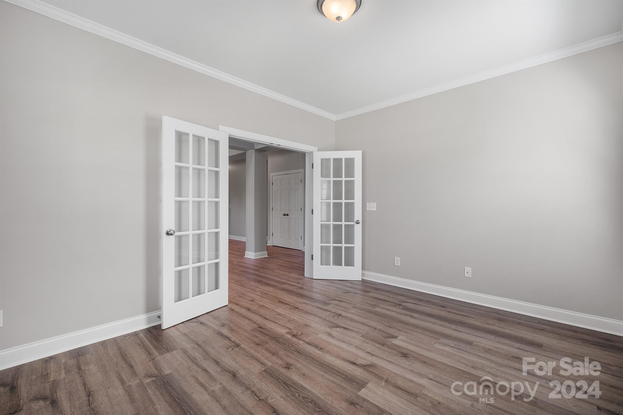 4009 Thorndale Road Indian Trail, NC 28079 - Photo 9 of 48 an empty room with wooden floor and windows