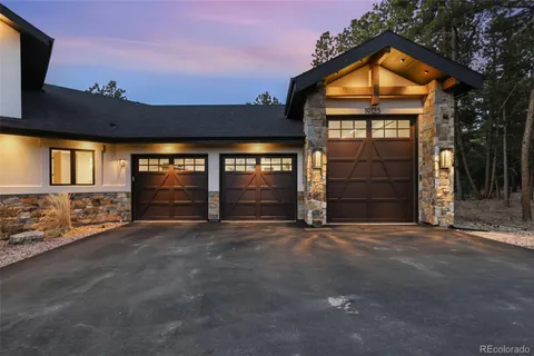 a bedroom with a large bed couch and a large window