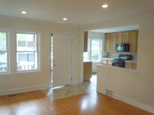 5303 North Rutherford Avenue Chicago, IL 60656 - Photo 2 of 16 a kitchen with a refrigerator and wooden floor