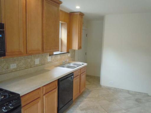 5303 North Rutherford Avenue Chicago, IL 60656 - Photo 5 of 16 a kitchen with a sink cabinets and a stove top oven