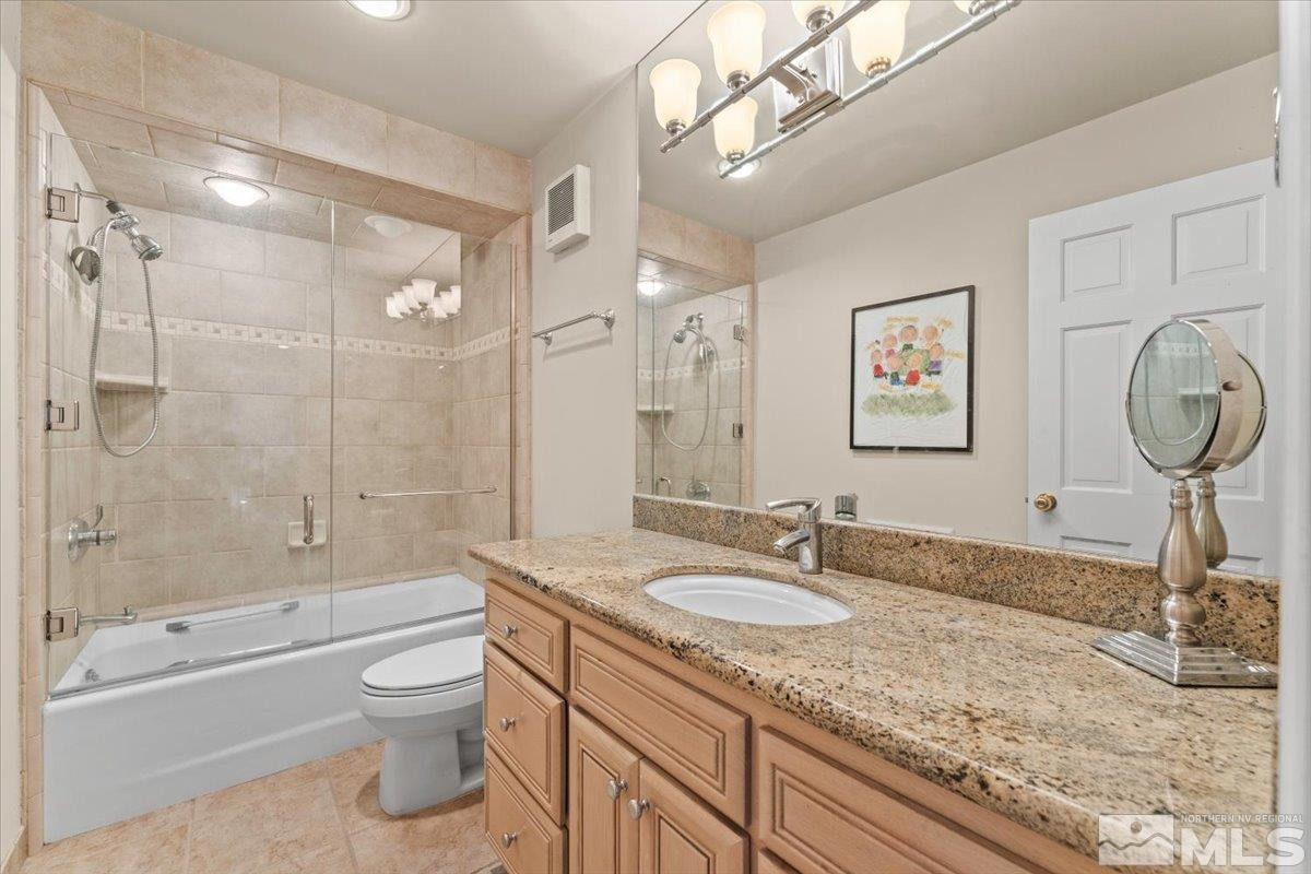 449 Fairview Boulevard Incline Village, NV 89451 - Photo 25 of 40 a bathroom with a granite countertop sink a toilet and bathtub
