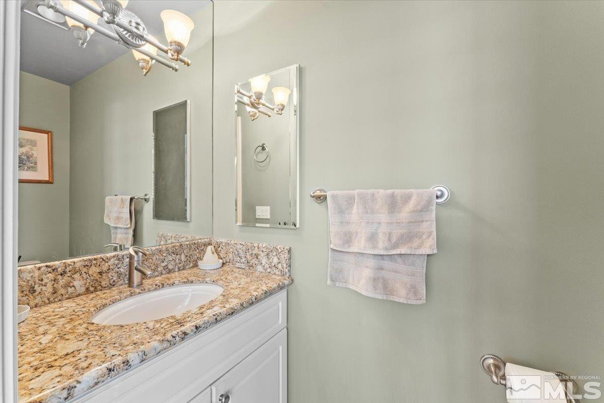 449 Fairview Boulevard Incline Village, NV 89451 - Photo 31 of 40 a bathroom with a granite countertop sink a mirror and a shower