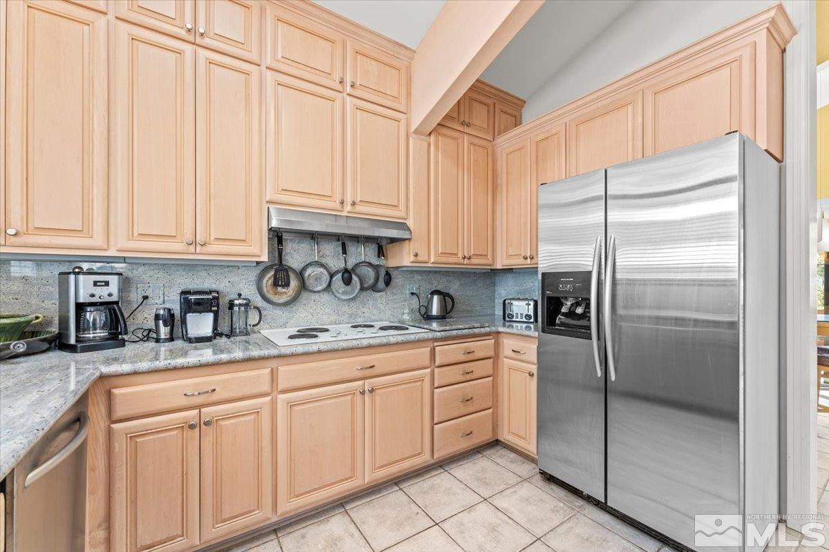 449 Fairview Boulevard Incline Village, NV 89451 - Photo 35 of 40 a kitchen with stainless steel appliances granite countertop a refrigerator sink and cabinets