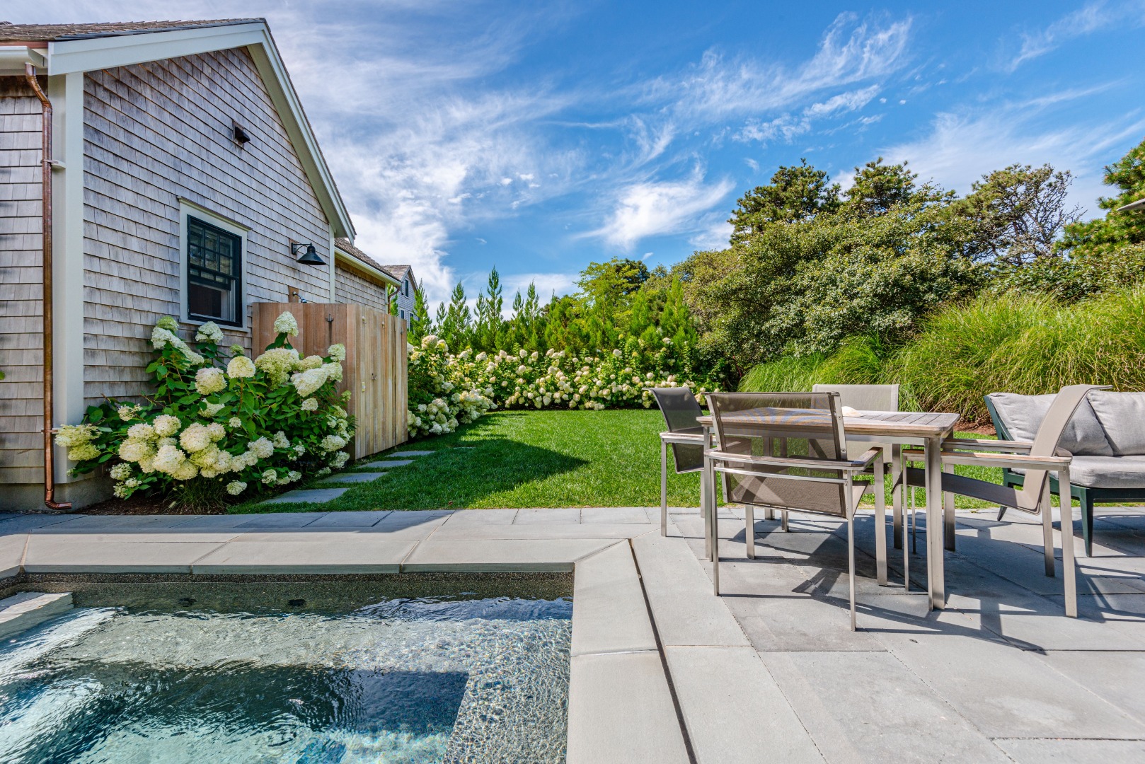3 Wood Lily Road Nantucket, MA 02554 - Photo 4 of 55 a table and chairs sitting in front of a house