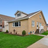a view of a white house with a yard