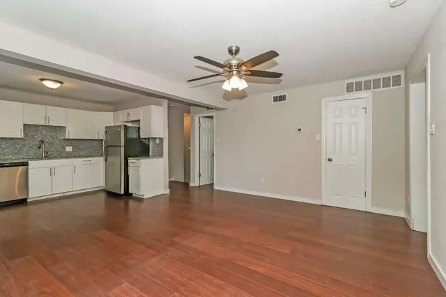 a view of a kitchen with a sink and a refrigerator