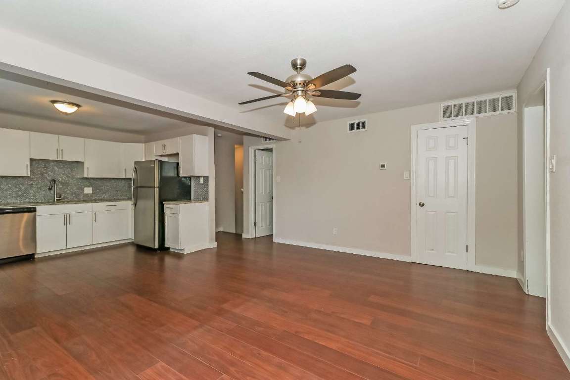 7202 Twin Crest Drive, Unit 103 Austin, TX 78752 - Photo 3 of 14 a view of a kitchen with a sink and a refrigerator