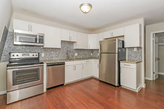 a kitchen with a refrigerator sink and microwave
