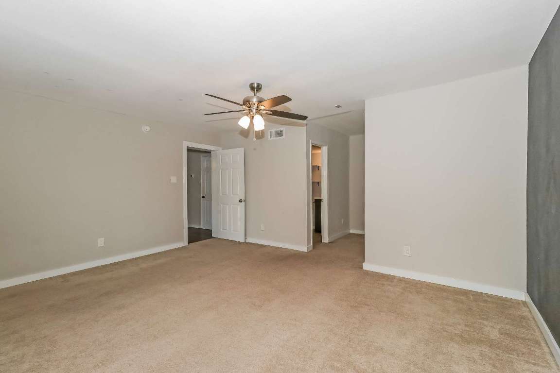 7202 Twin Crest Drive, Unit 103 Austin, TX 78752 - Photo 8 of 14 a view of an empty room with a chandelier fan
