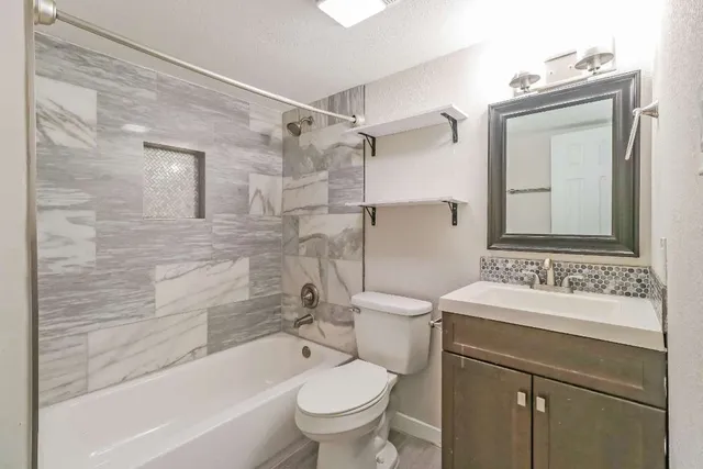 a bathroom with a sink toilet and shower